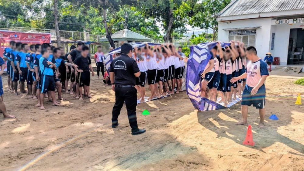Drug rehabilitation students participate in physical games at the program. Photo: Binh An
