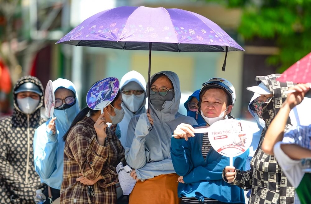 Đông đảo phụ huynh đội nắng chờ con tại điểm thi. Ảnh: Quách Du