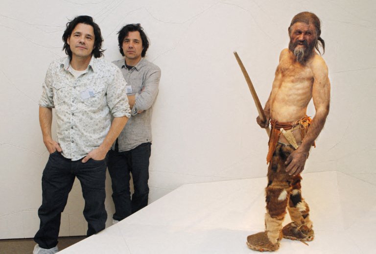 2 Dutch artists stand next to the restored statue of the Otzi ice mummy discovered in Italy. Photo: AFP