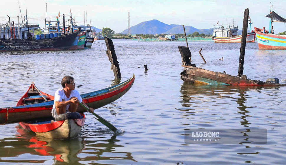 Ngư dân lặng người nhìn phần còn sót lại của con tàu bị cháy rụi. Ảnh: Hoài Phương
