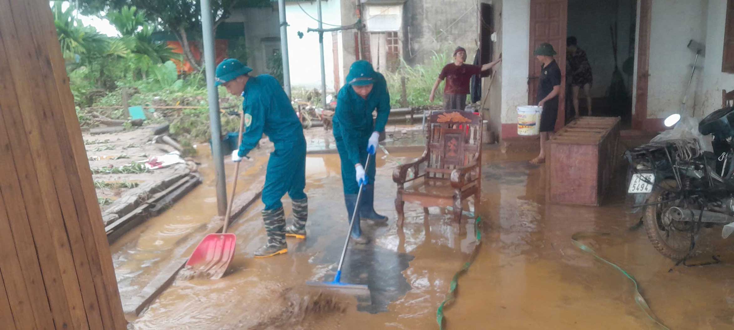 Lực lượng quân sự phường Âu Lâu hỗ trợ người dân vệ sinh nhà cửa sau khi nước lũ rút. Ảnh: Phường Âu Lâu