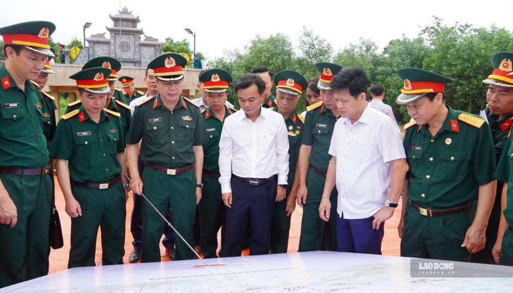 The Steering Committee for searching, repatriating and identifying martyrs' remains of Quang Tri province inspects the field, and checks the map to determine the location of the martyr's grave in Cau Nhi. Photo: Hung Tho