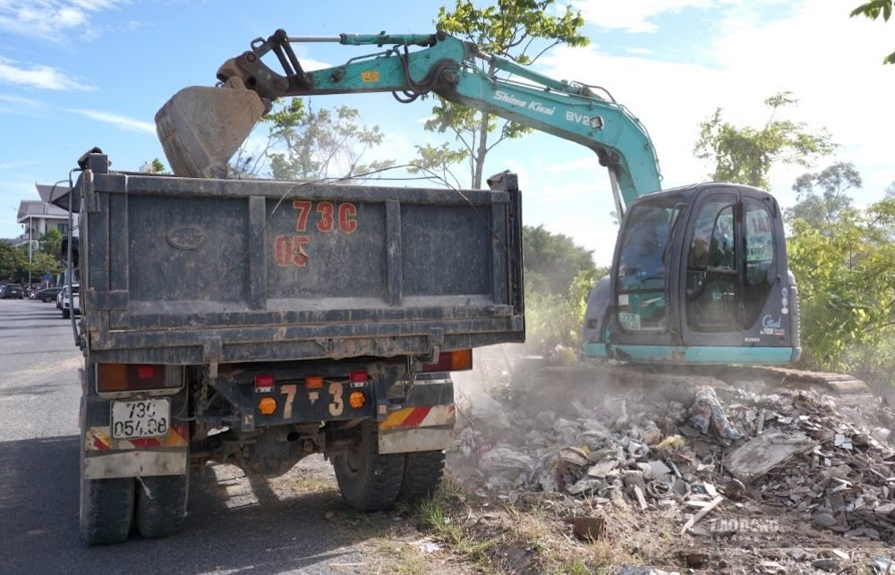 Lượng rác lớn, kéo dài dọc đường Nguyễn Hữu Thọ khiến việc thu gom gặp không ít khó khăn. Ảnh: Nguyễn Luân