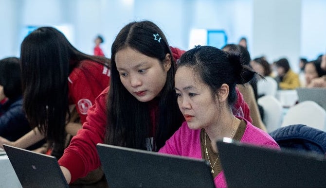 Tu Trinh (red shirt) at a training session for teachers on digital transformation. Photo: Student provided