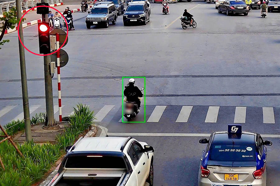 AI camera records traffic tickets for motorbikes running red lights. Photo: Hanoi Police