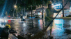 Environmental workers work in the rain, keeping streets clean