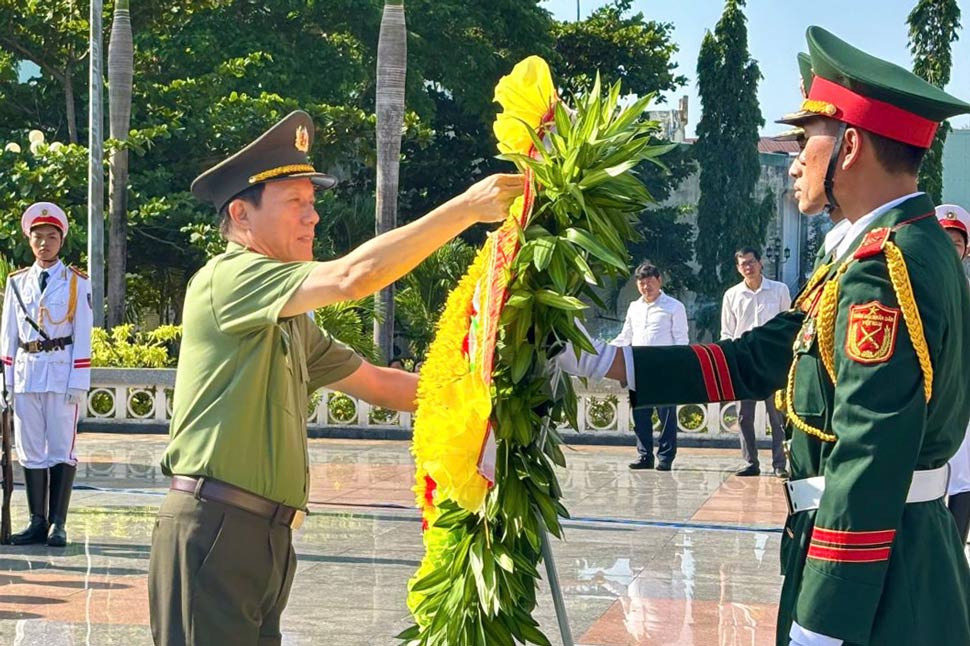 Đại tướng Lương Tam Quang chỉnh vòng hoa dâng lên các anh hùng liệt sĩ. Ảnh: Cổng thông tin tỉnh Gia Lai