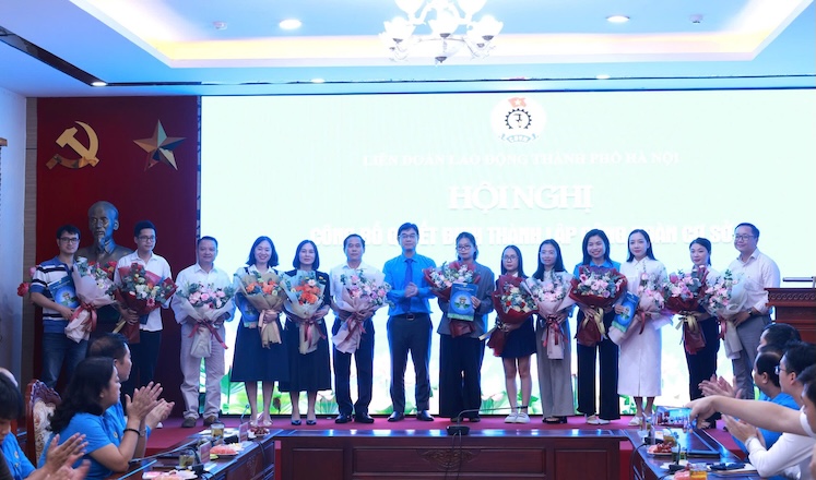 Mr. Nguyen Van Thang - Member of the Standing Committee of the Vietnam General Confederation of Labour, Chairman of the Hanoi Labor Federation (8th from right) presents the Decision on establishing grassroots trade unions to units. Photo: Ngoc Anh