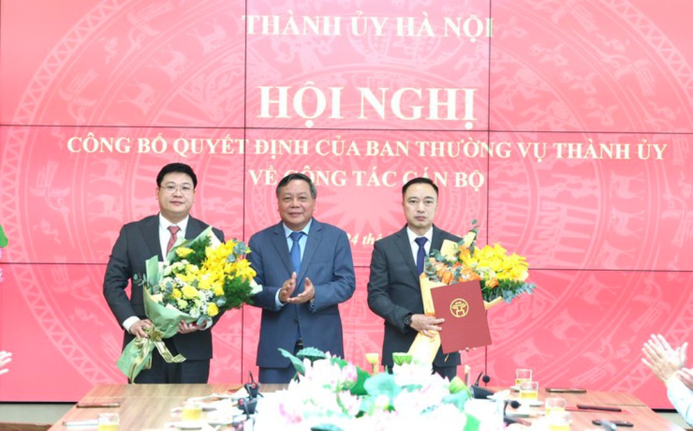 Phó Bí thư Thành ủy Nguyễn Văn Phong trao quyết định về công tác cán bộ cho ông Phạm Minh Hoàng (ngoài cùng bên phải) và ông Trần Đức Trung Tiến. Ảnh: Hanoi.gov.vn
