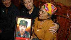 Staying up many nights restoring portraits to give to relatives of martyrs, wearyly waiting for the day to receive the remains.