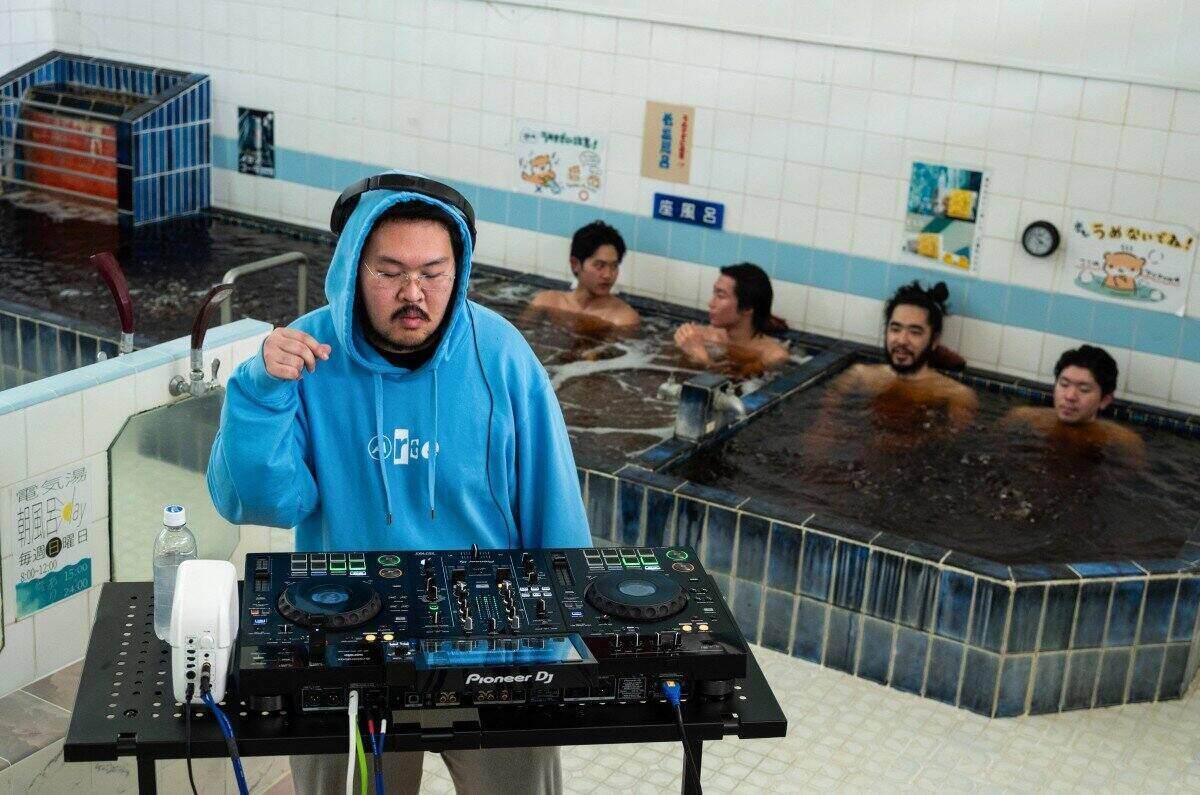 DJ Zendo performs in the Login.jp project at Denki-yu bathhouse (Sumida district, Tokyo, Japan) amidst the relaxing space of tourists. Photo: AFP