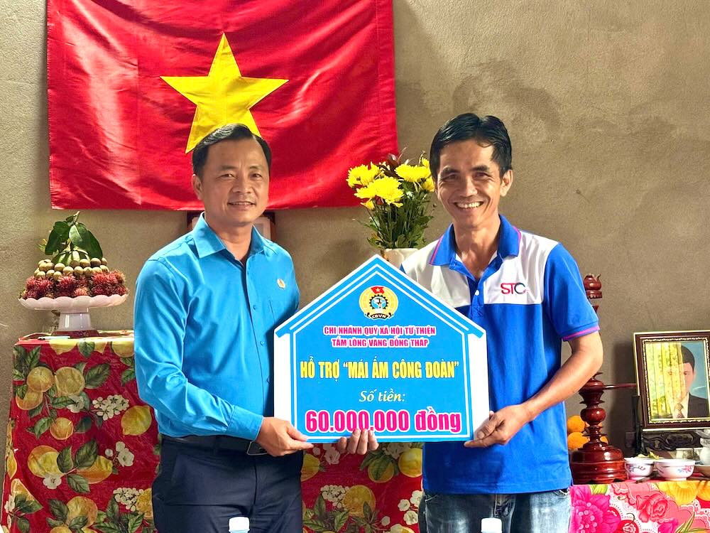 Ông Nguyễn Thanh Tuấn – Phó Chủ tịch LĐLĐ tỉnh Đồng Tháp trao bảng tượng trưng hỗ trợ kinh phí xây dựng “Mái ấm Công đoàn“. Ảnh: Thanh Nhàn. 