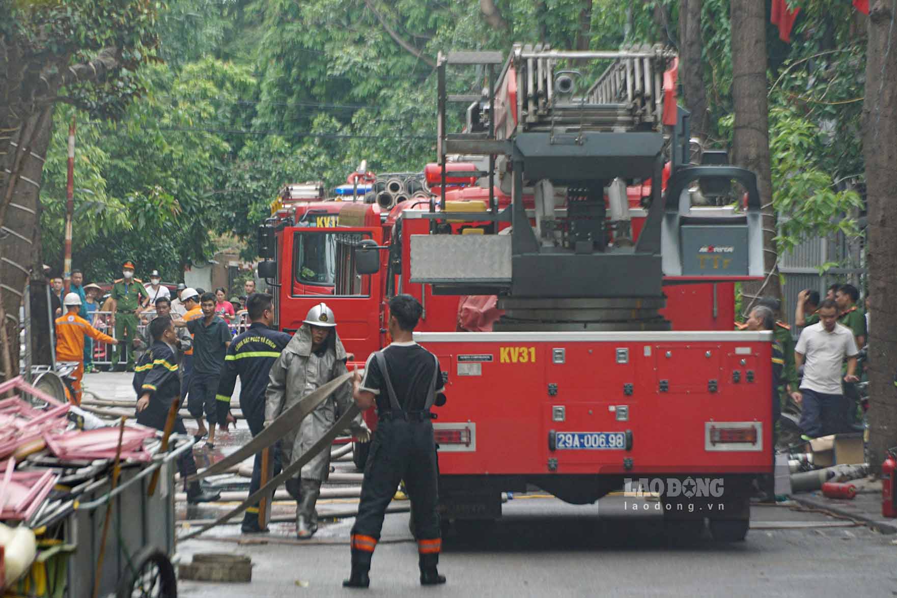Police seal off the scene of a 4-story house fire in Hanoi