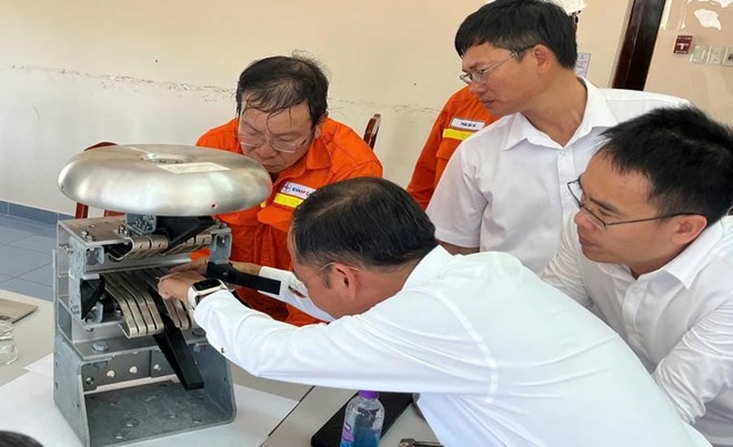 Anh Phạm Hiếu Trung (ngoài cùng bên phải) cùng đồng nghiệp nghiên cứu dao cách ly tại Trạm biến áp 500kV Vĩnh Tân. Ảnh: Công đoàn Điện lực Việt Nam