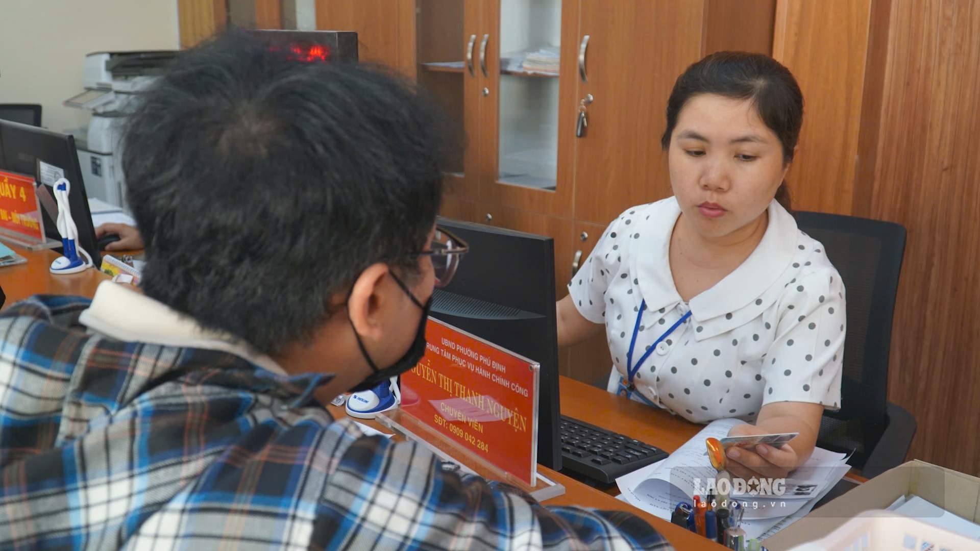 Cán bộ hướng dẫn người dân làm thủ tục. Ảnh: Minh Tâm