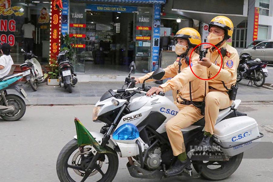 Traffic police patrol with professional cameras equipped. Photo: Tien Ngo