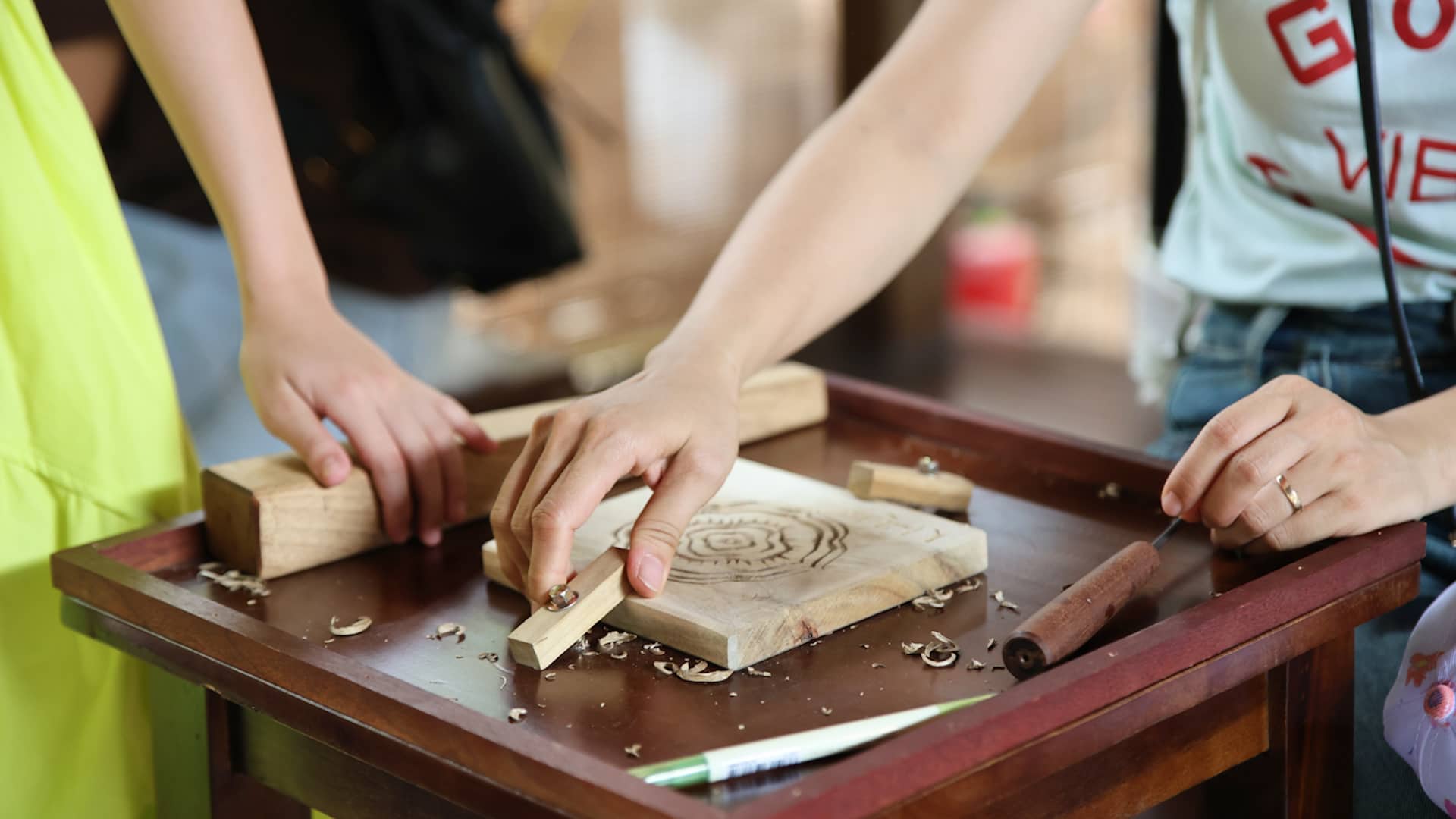 Dưới sự hướng dẫn trực tiếp của nghệ nhân, du khách được sử dụng các dụng cụ thủ công cơ bản để tự tay chạm khắc lên những tấm ván gỗ, tạo nên các họa tiết mang ý nghĩa hiếu học, tôn sư trọng đạo và gìn giữ giá trị văn hóa truyền thống. Ảnh: Văn Miếu - Quốc Tử Giám