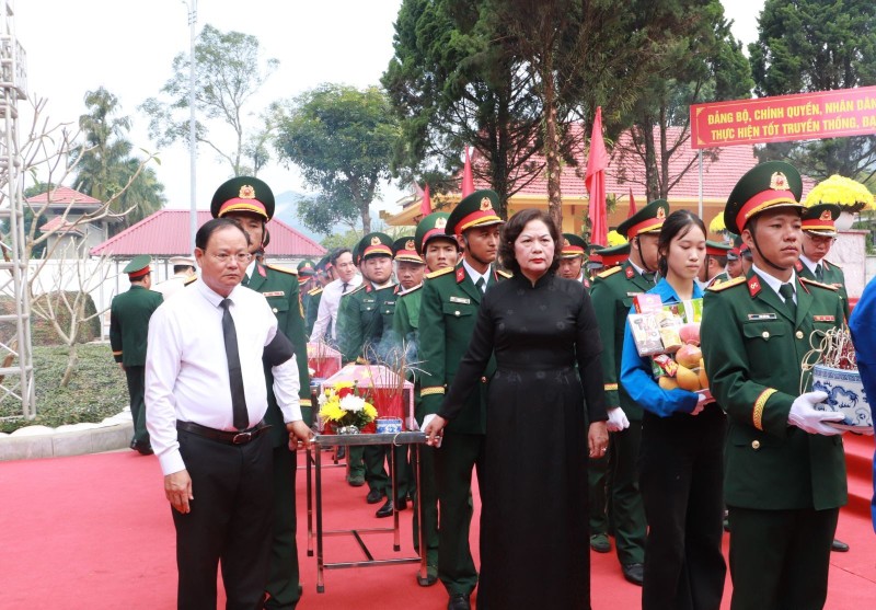 Phó Chủ tịch Quốc hội Nguyễn Thị Hồng thực hiện nghi thức thỉnh trống. Tiếp đó, Lãnh đạo Trung ương, Quân khu 2 và tỉnh Lai Châu thực hiện nghi thức di quan, đưa các liệt sĩ về nơi an nghỉ cuối cùng. Ảnh: Laichau.gov.vn