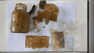 Paper sample containing martyr information in a glass jar. Photo: Economic - National Defense Team 337