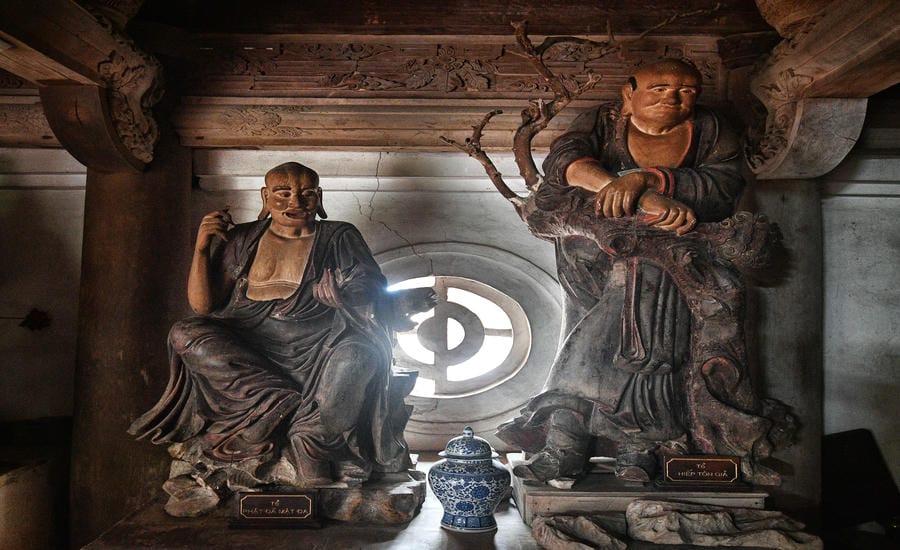 The two La Han monks of Tay Phuong Pagoda vividly appeared in a narrow stream of light through the round window.