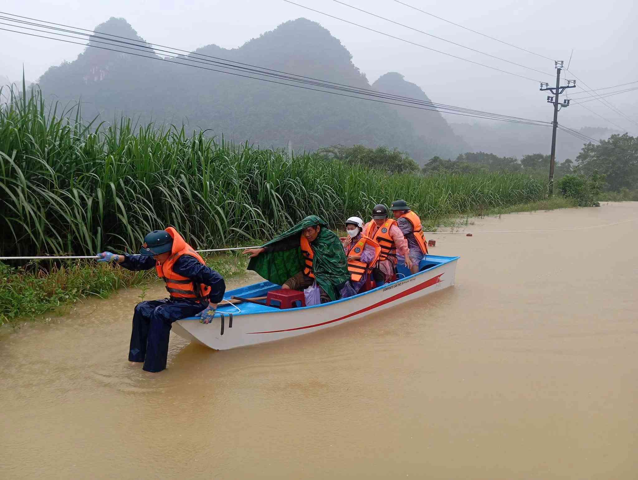 Functional forces support people to pass through deep flooded areas. Photo: Cao Bang Military Command.