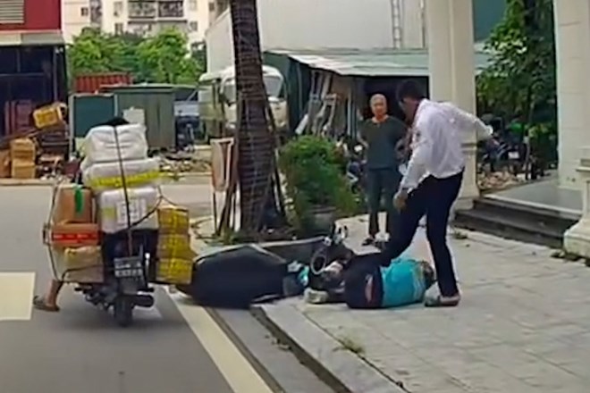 Người đàn ông mặc áo bảo vệ hành hung tài xế công nghệ tại khu đô thị Louis City Hoàng Mai (Hà Nội). Ảnh: Bạn đọc Lý Hùng cung cấp