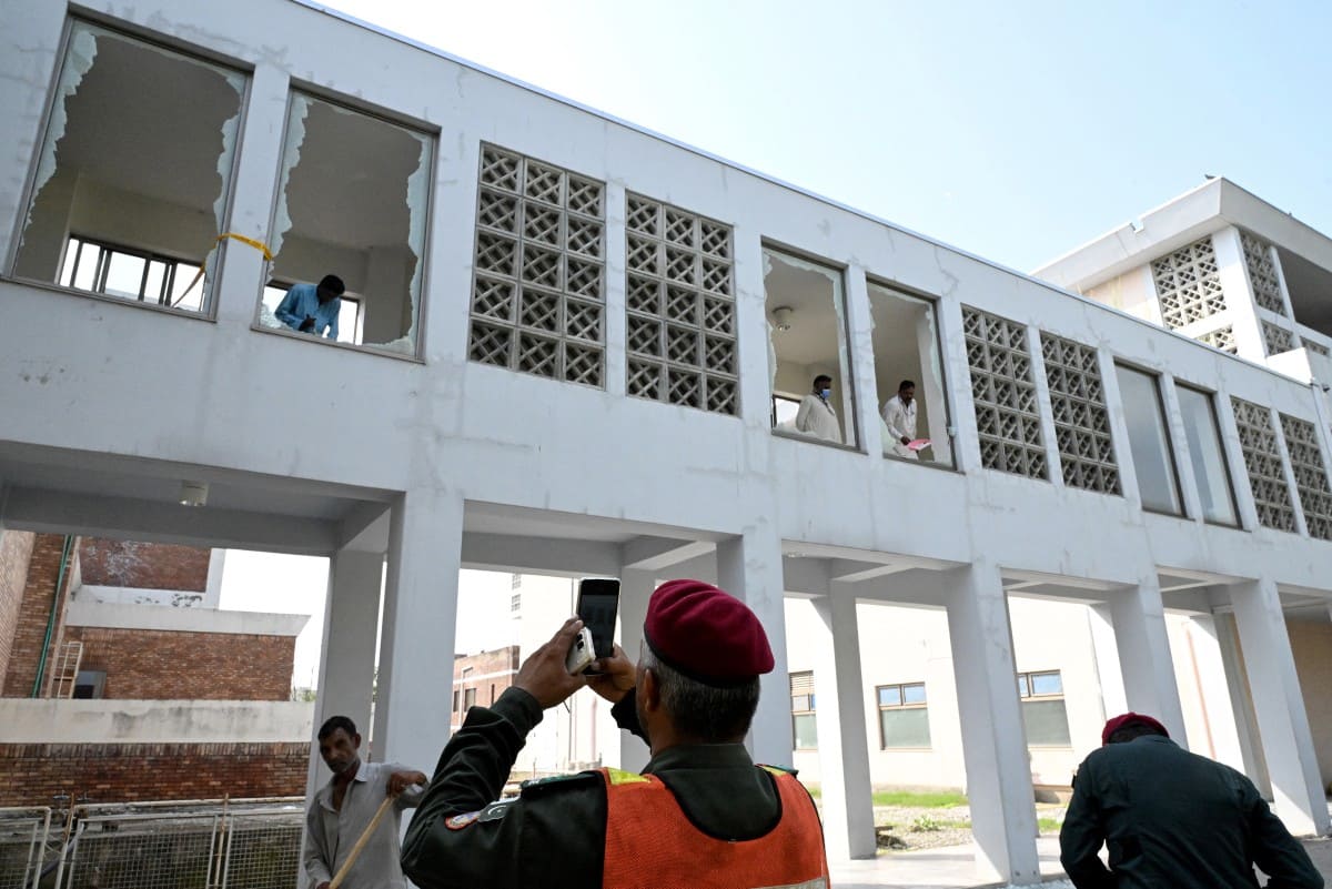 Workers clear broken glass after a fire at a hospital in Pakistan. Photo: AFP