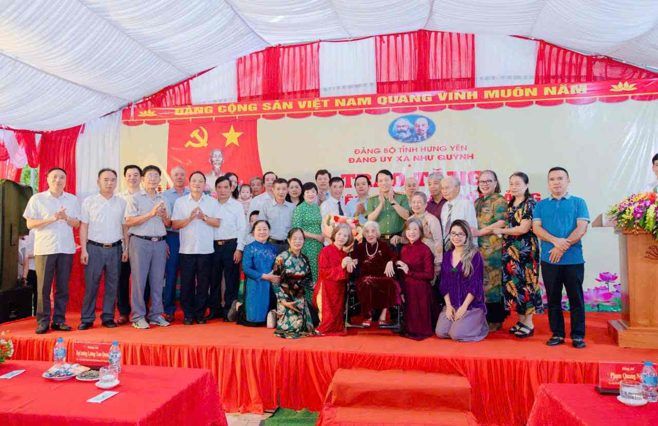 Đại tướng Lương Tam Quang và các đại biểu chụp ảnh lưu niệm cùng đảng viên Quản Thị Sành. Ảnh: Công an tỉnh Hưng Yên