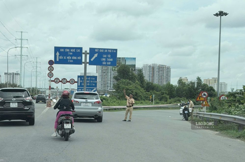 Do lượng xe đông, CSGT luân phiên đóng mở các đường dẫn lên cao tốc để điều tiết. Trong ảnh tại lối lên cao tốc gần nút giao Phú Hữu, lực lượng chức năng đang hạn chế xe lên. Ảnh: Như Quỳnh