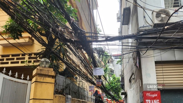 Dây điện, cáp viễn thông chằng chịt như mạng nhện tại các ngõ phố của Hà Nội. Ảnh: Minh Hạnh 