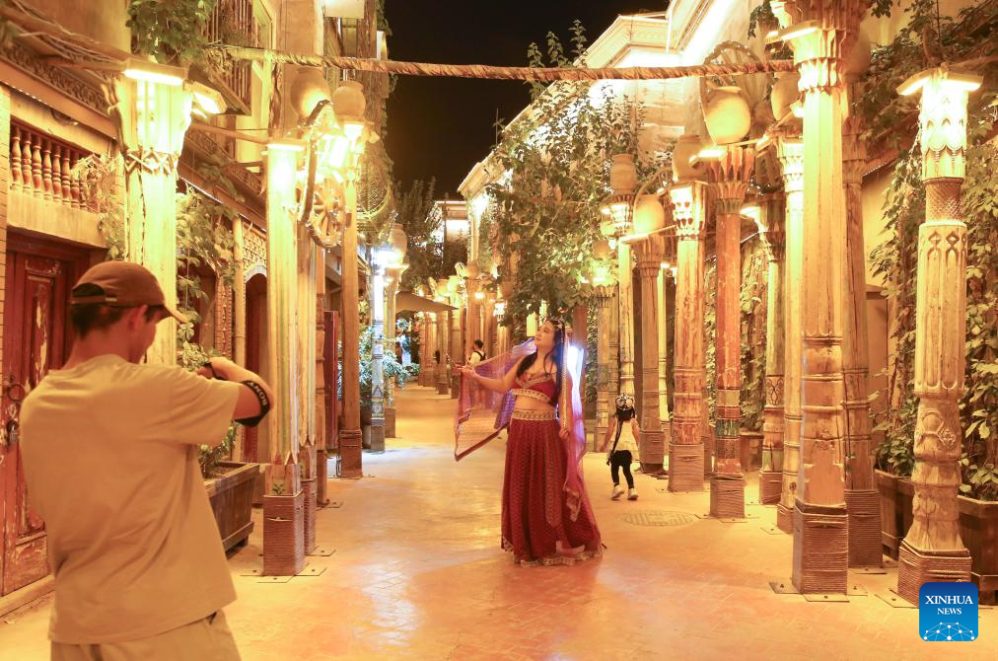 tourists pose for photos at the Kashgar Ancient Citadel scenic area during a trip to China. Photo: Xinhua
