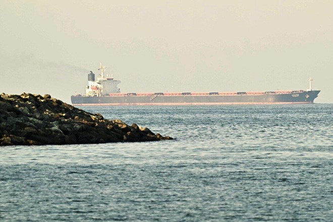 A cargo ship passes through the Strait of Hormuz on February 25, 2026. On August 5, Iran said it had reached a preliminary agreement with Oman on opening a temporary maritime route through this strait. Photo: AFP
