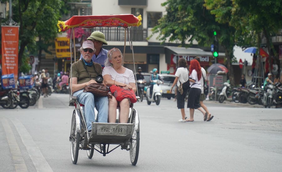 International tourists sitting in cyclos traveling in Hanoi. Photo: Minh Chinh