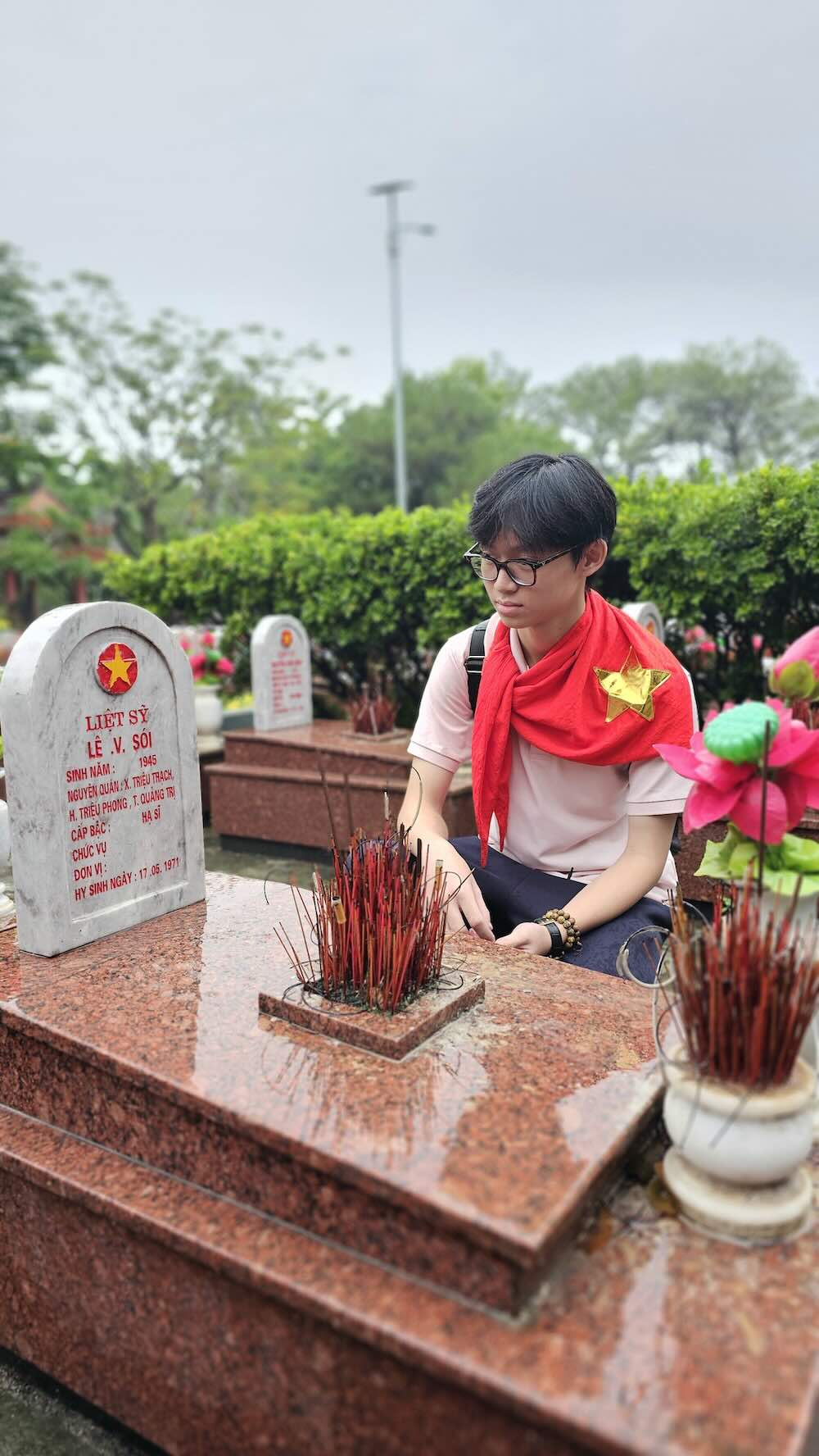 Người trẻ đội mưa dâng hương tại Nghĩa trang Trường Sơn dịp Quốc khánh. Ảnh: Nguyễn Luân