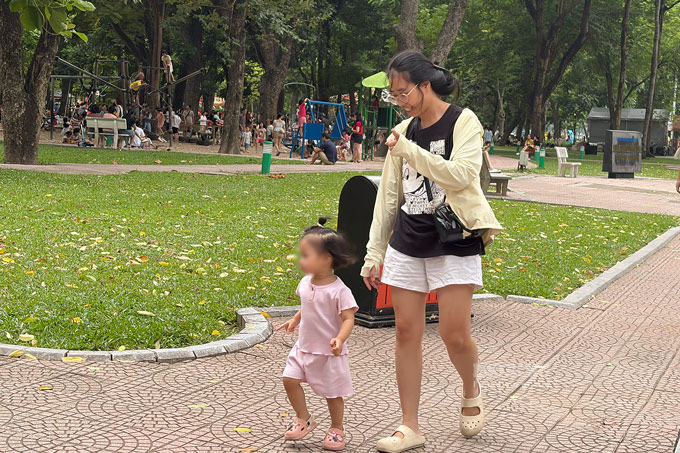 Khác với những ngày hè nóng bức, hôm nay gia đình chị Mai Bùi lựa chọn trang phục thoải mái, nhẹ nhàng khi đưa con đi chơi công viên. Các thành viên cũng không cần mang theo mũ hay quạt để chống nóng. Ảnh: Minh Châu