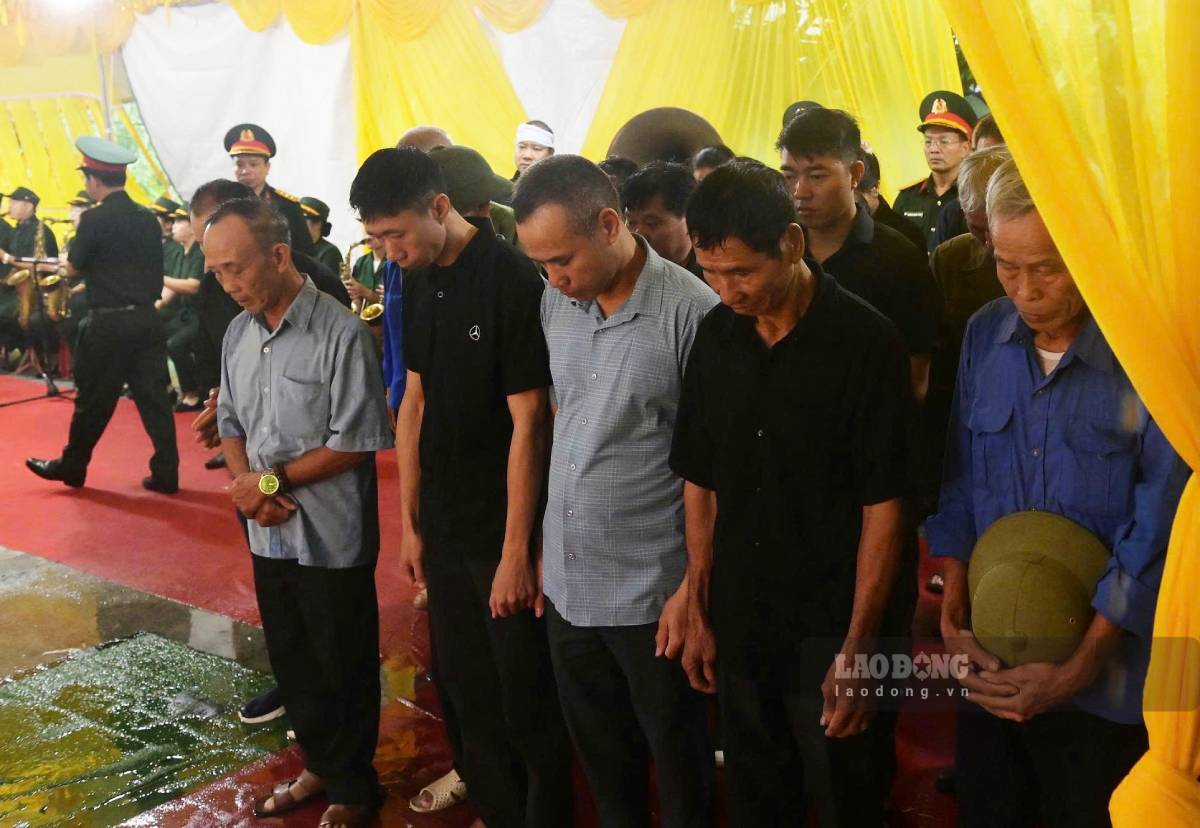 Dòng người đội mưa đến