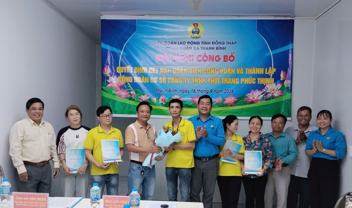 Representatives of the Provincial Labor Federation and the Board of Directors of Phuc Thinh Fashion Co., Ltd. present the Decision on establishing the grassroots Trade Union and present flowers to congratulate. Photo: Luu Hung