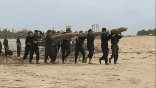Dry firewood and garbage fill Nhat Le beach, forces clean up at full capacity. Photo: Cong Sang