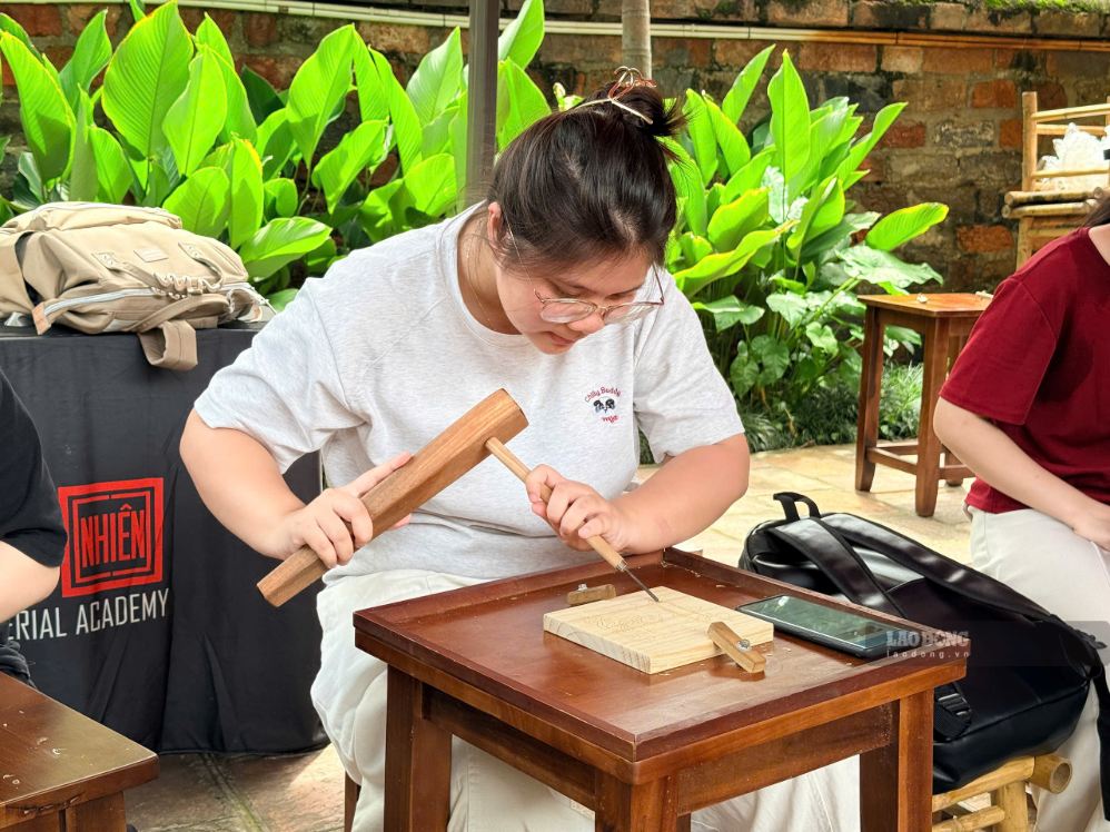 Từng nét chạm trên phôi gỗ được thực hiện tỉ mỉ dưới sự hướng dẫn của nghệ nhân. Ảnh: Thảo Anh