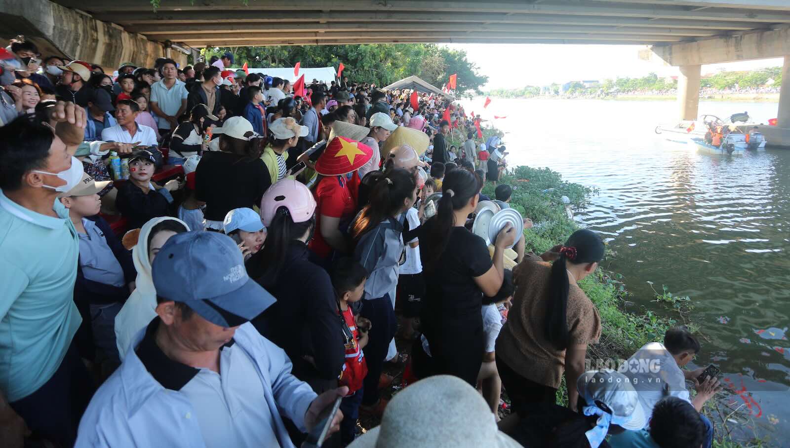 Thousands of people gather on both banks of the Kien Giang River to cheer for boat racing. Photo: Cong Sang