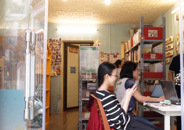 Young people come to D Free Book - a free library in Hanoi. Photo: Huong Ly