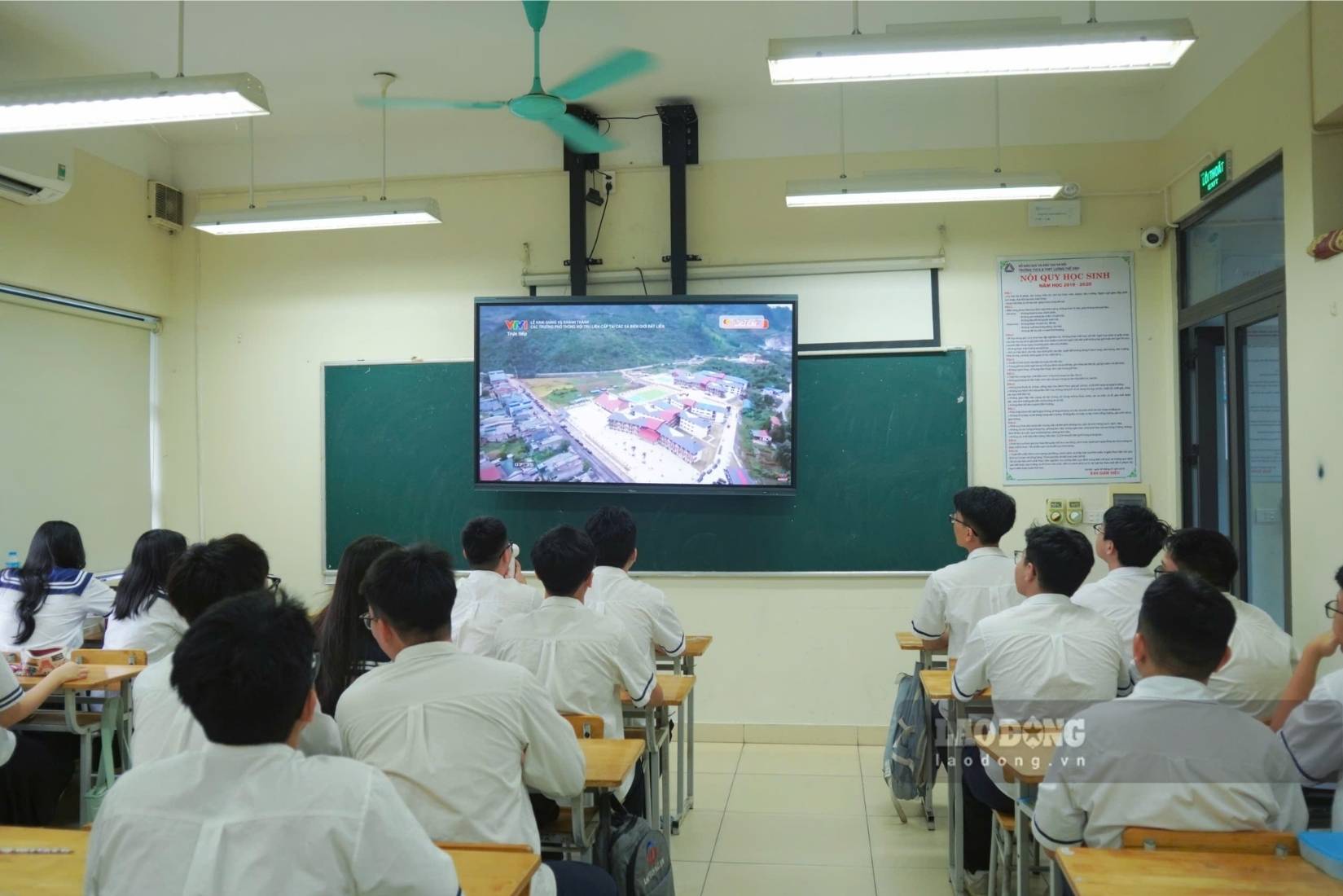 Students watch the opening ceremony and inauguration of inter-level boarding schools through a screen in the classroom. Photo: Thanh Binh