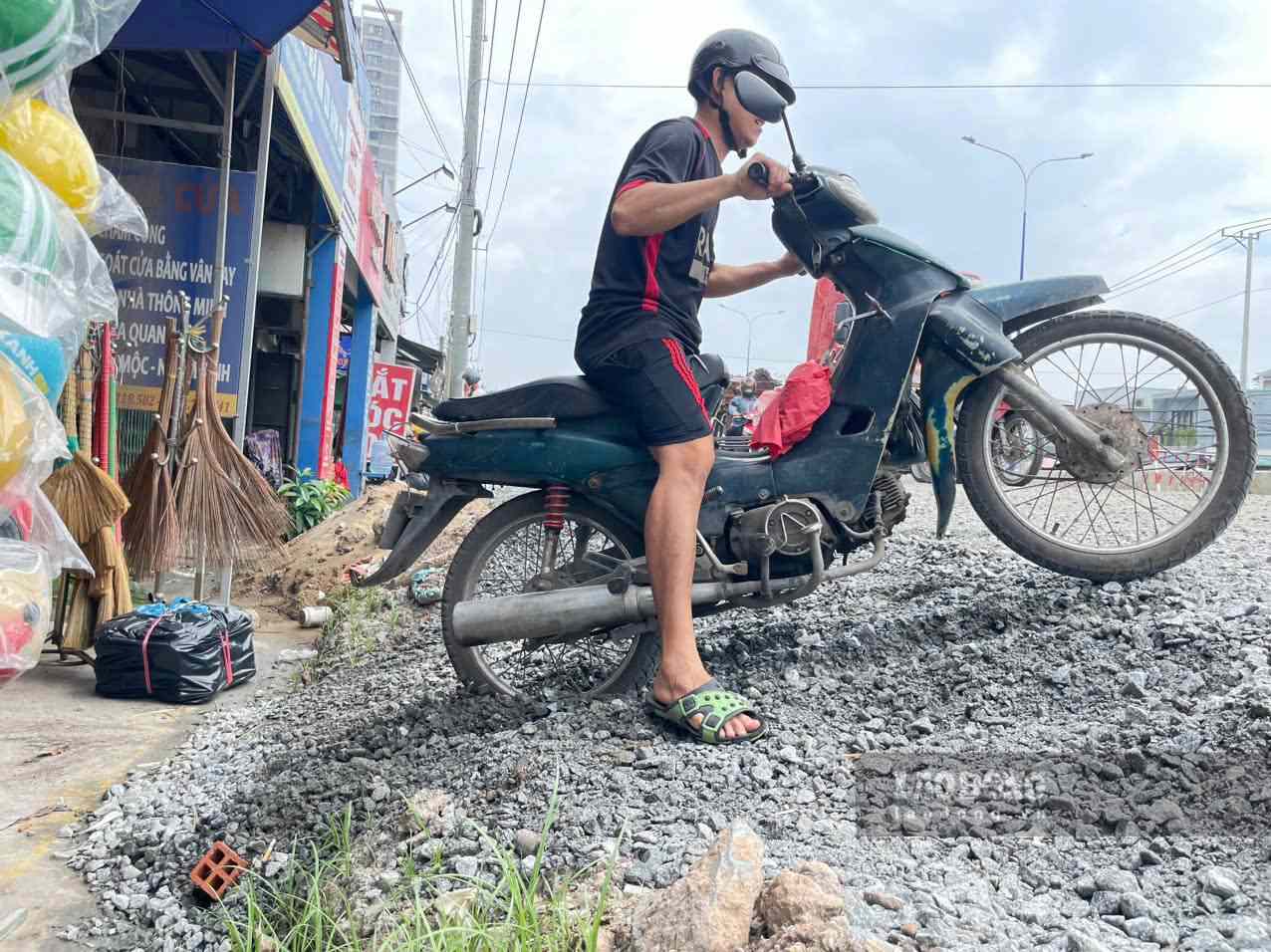 国道13号線の路盤が嵩上げされ、住民は家に出入りするのに苦労しています。写真:ディン・チョン