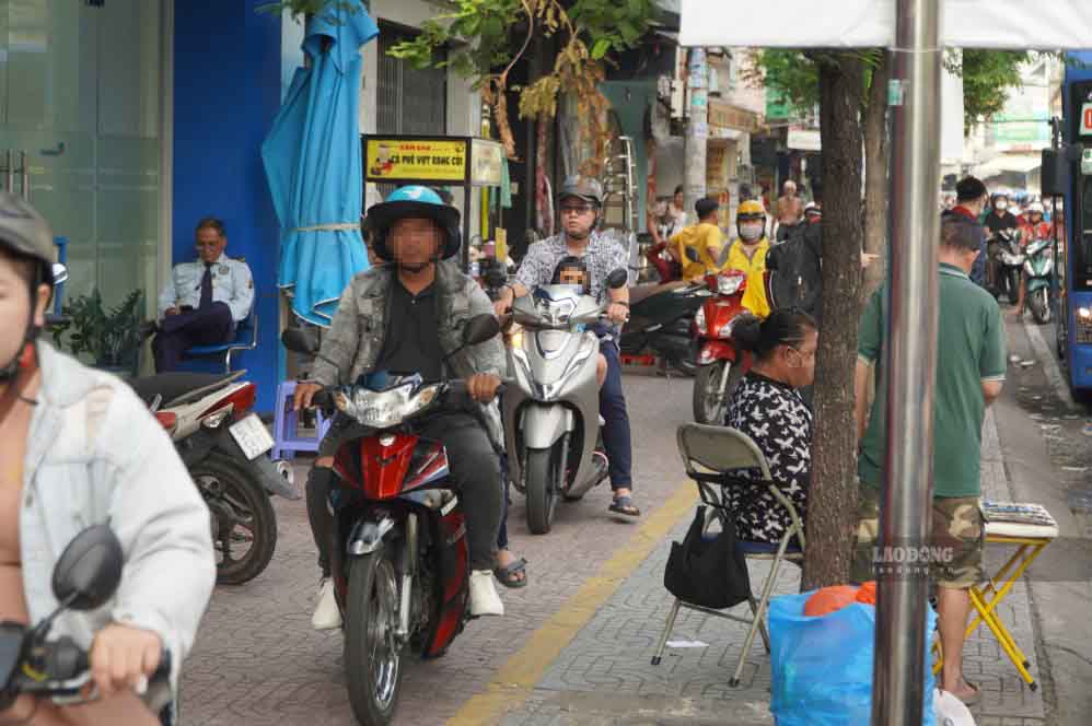Một số người dân điều khiển xe lên vỉa hè để tránh đoạn đường ùn ứ. Ảnh: Chân Phúc