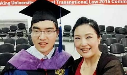 Ding chụp ảnh cùng mẹ trong ngày lễ tốt nghiệp khoa luật quốc tế thuộc trường Đại học Bắc Kinh năm 2015. Ảnh: Tân Hoa Xã.