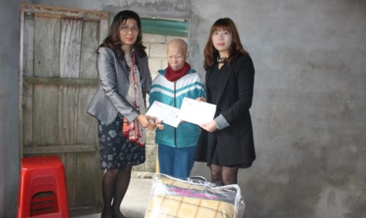 Bà Hà Thị Mai Hương - PGĐ Quỹ XHTT Tấm lòng vàng (bên trái) cùng đại diện Hiệp Hội giao lưu Việt Nam tại Hàn Quốc trao tiền và chăn ấm hỗ trợ hoàn cảnh gia đình bà Thủy. Ảnh: Trần Tuấn