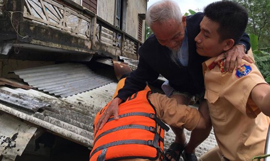 Cảnh sát giao thông tỉnh Quảng Trị giúp dân sơ tán khỏi vùng bị ngập lụt vào sáng 1.11. Ảnh: LÂM HƯNG THƠ