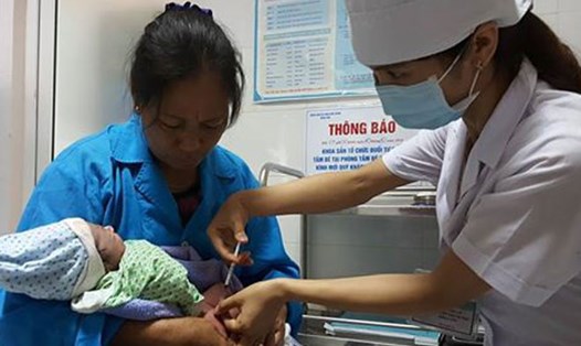 Cán bộ y tế tiêm phòng virus viêm gan B cho trẻ sơ sinh.